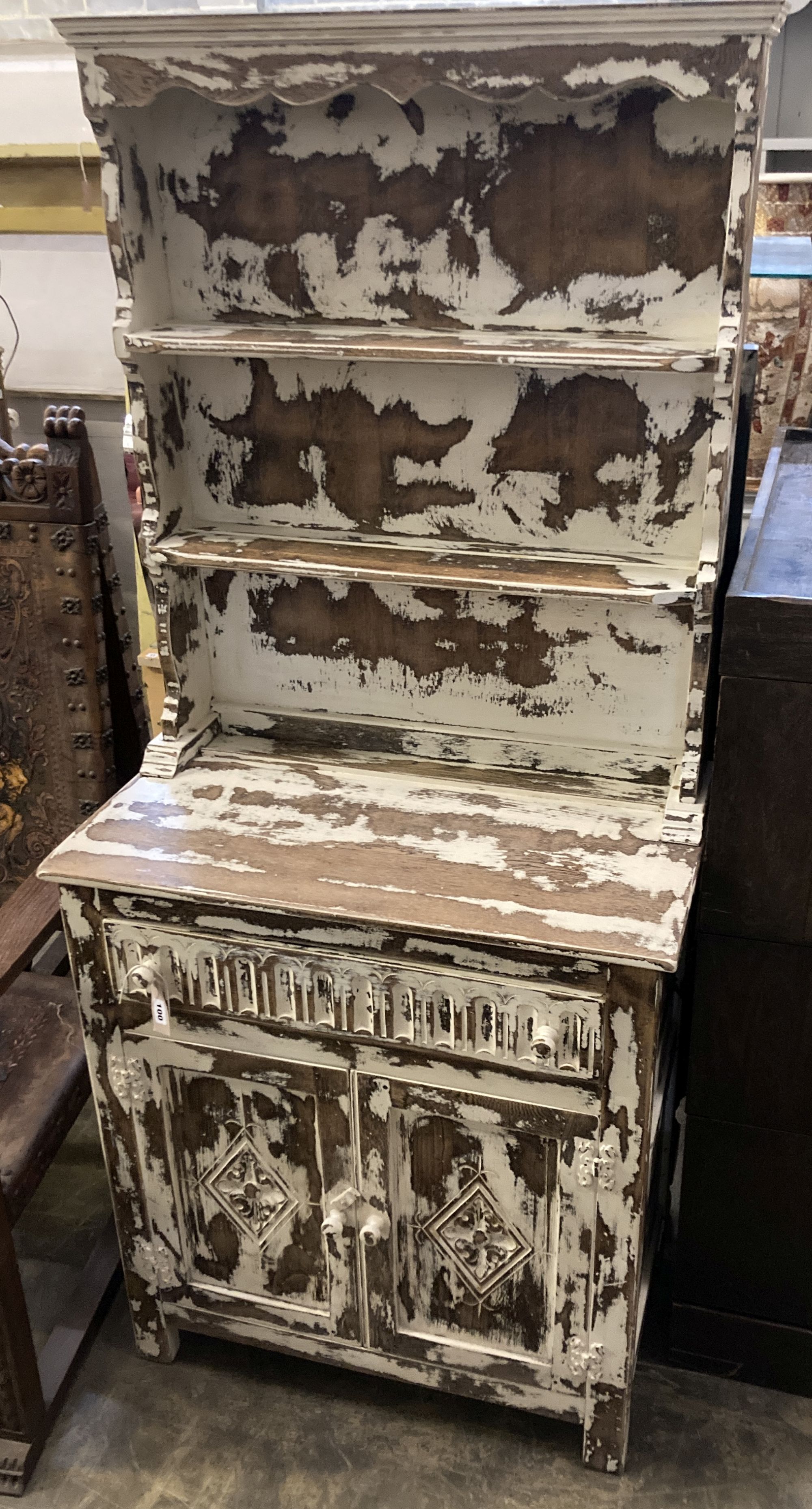 A 1920s oak narrow dresser with distressed paintwork, width 76cm, depth 42cm, height 175cm